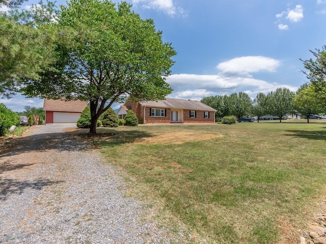 ranch-style home featuring a garage and a front lawn