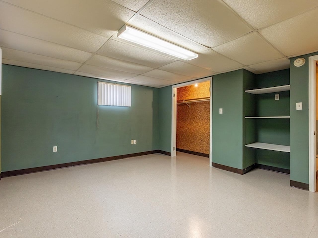 basement featuring a paneled ceiling