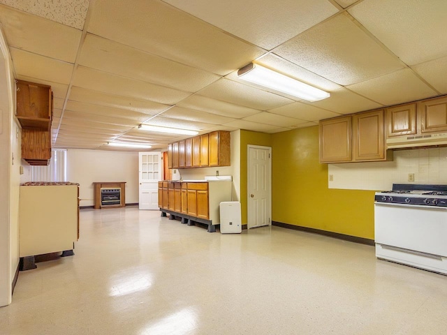 kitchen featuring a paneled ceiling, white range with gas stovetop, and wine cooler