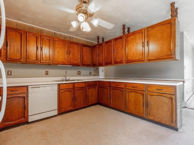 kitchen featuring ceiling fan, dishwasher, sink, and a textured ceiling