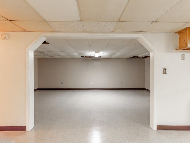 basement with a paneled ceiling