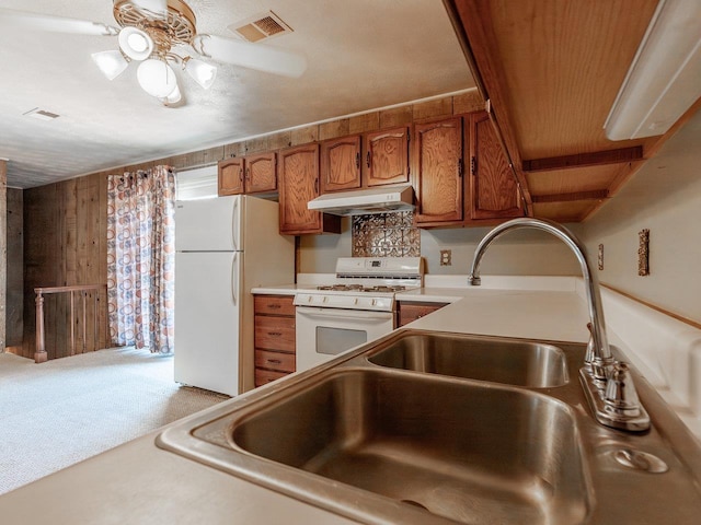 kitchen with ceiling fan, white appliances, and carpet