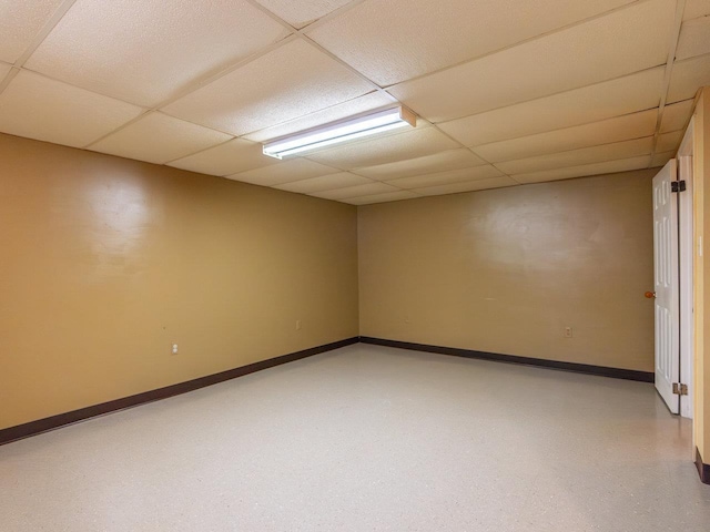 unfurnished room featuring a drop ceiling