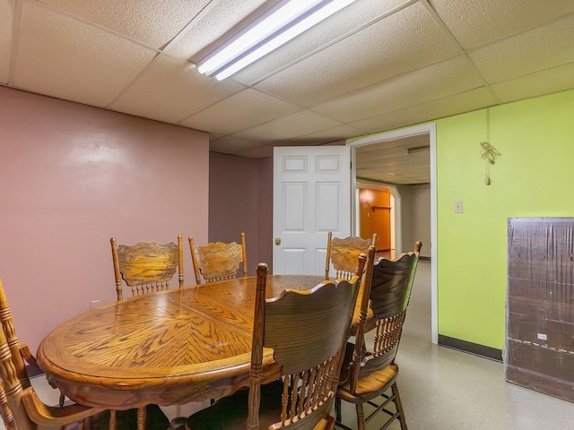 dining space with a drop ceiling