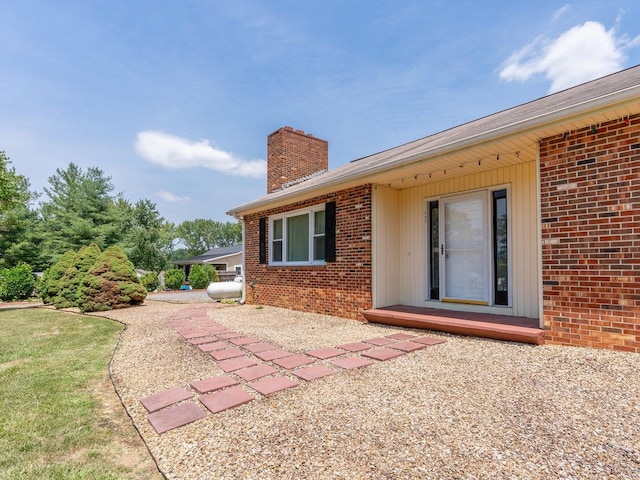 back of property featuring a lawn