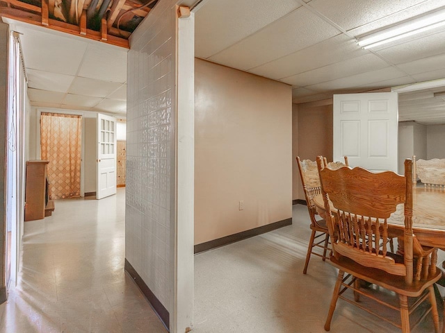 dining area featuring a drop ceiling