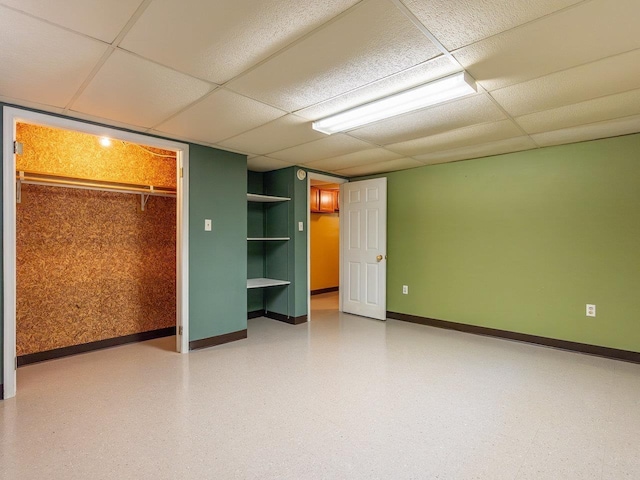 unfurnished bedroom with a paneled ceiling and a closet