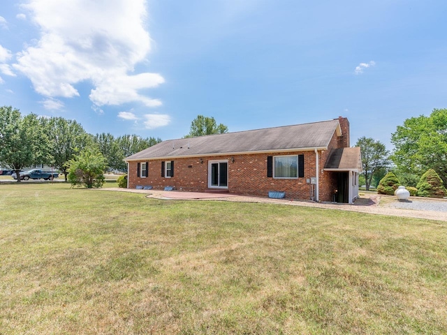 back of property featuring a yard and a patio area