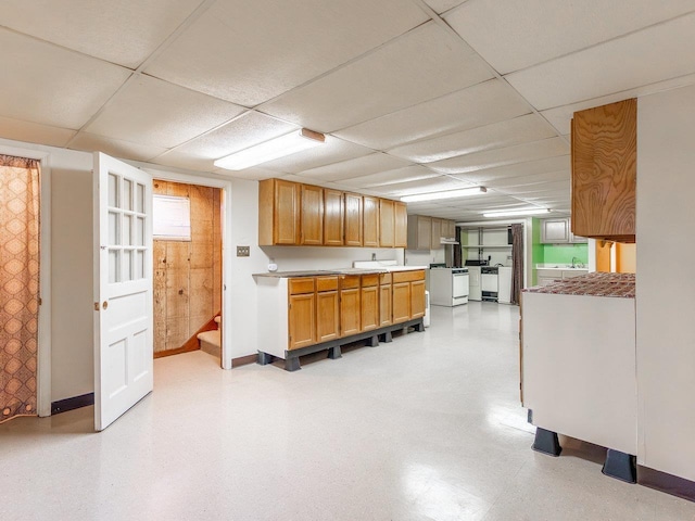 kitchen with a paneled ceiling and white range