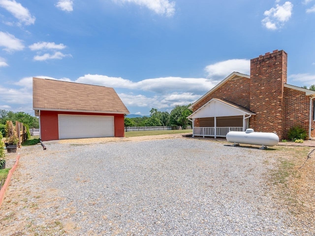 exterior space featuring a garage and an outbuilding