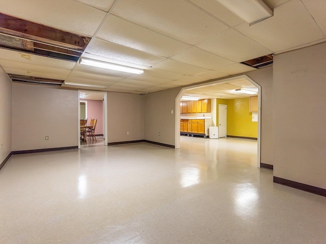 basement with a paneled ceiling