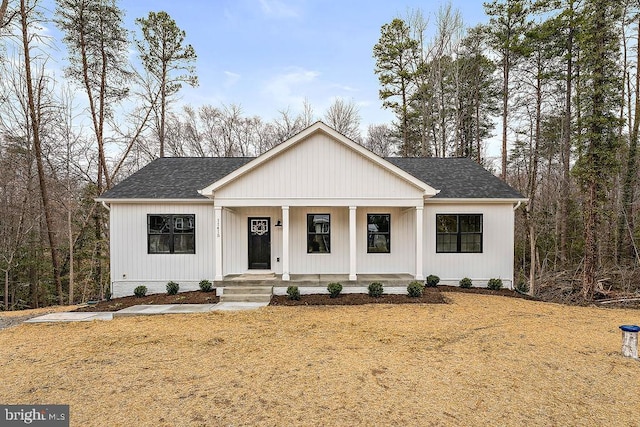 modern farmhouse style home featuring a porch and a shingled roof