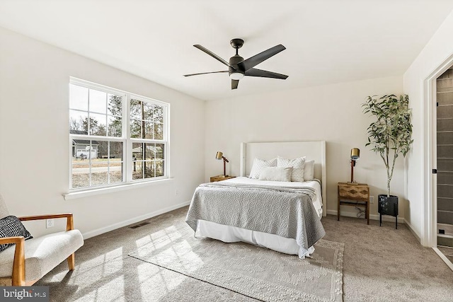 bedroom featuring visible vents, a ceiling fan, baseboards, and carpet floors