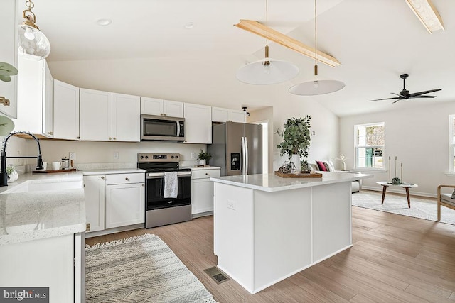 kitchen with visible vents, light wood-type flooring, white cabinets, stainless steel appliances, and a sink