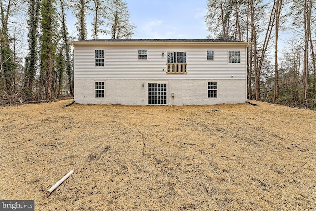 back of property featuring brick siding