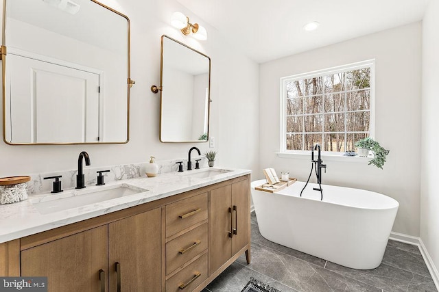 bathroom with a soaking tub, double vanity, visible vents, and a sink