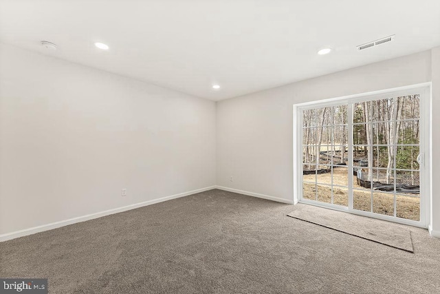 carpeted empty room with visible vents, recessed lighting, and baseboards