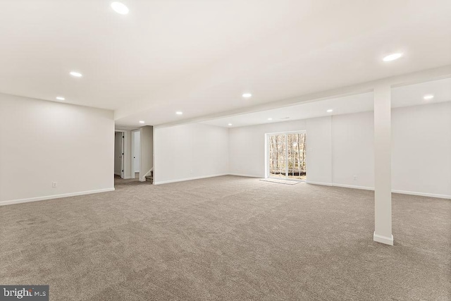 below grade area featuring stairway, carpet flooring, recessed lighting, and baseboards