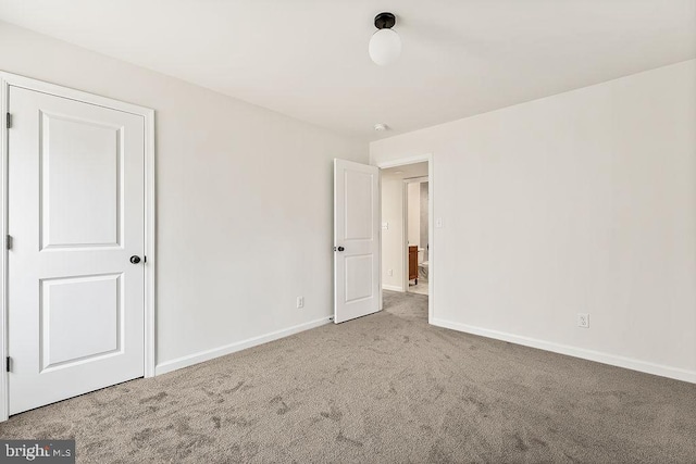 unfurnished bedroom with baseboards and carpet flooring