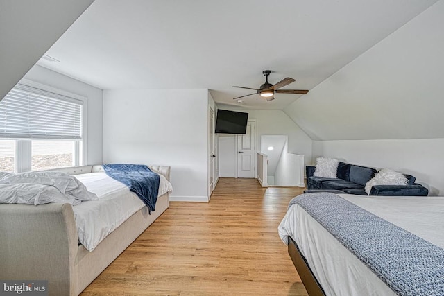 bedroom featuring lofted ceiling, light hardwood / wood-style floors, and ceiling fan