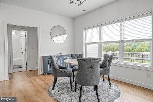 dining space featuring light wood-type flooring