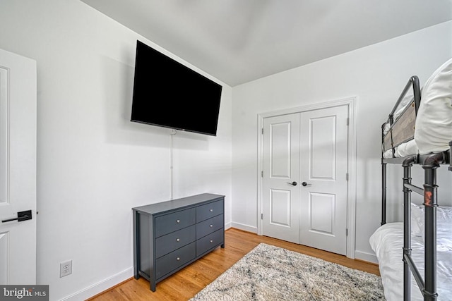 bedroom featuring light hardwood / wood-style floors and a closet