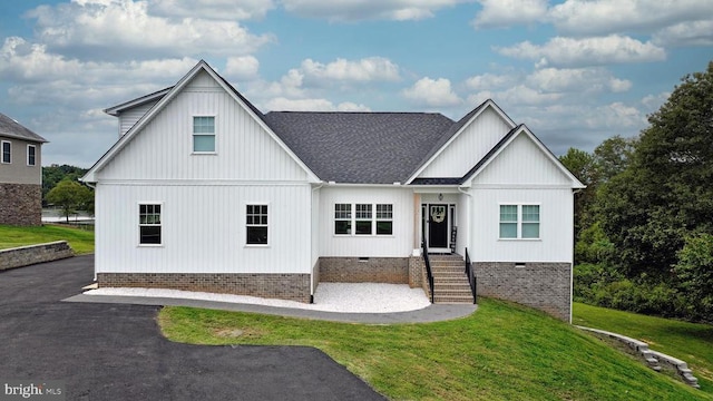 modern inspired farmhouse featuring a front lawn