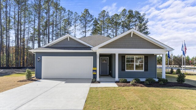 view of front of property with a garage and a front yard