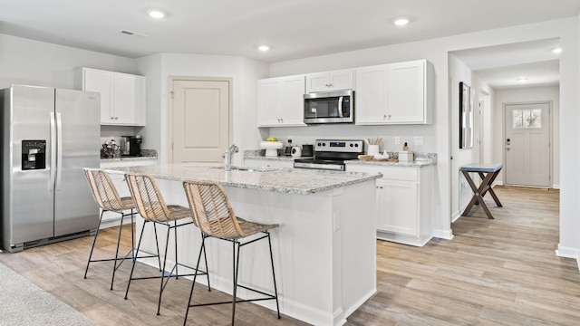 kitchen featuring white cabinetry and appliances with stainless steel finishes