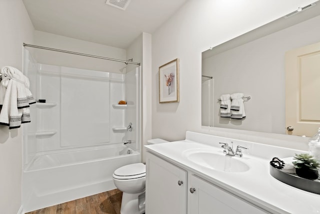 full bathroom with washtub / shower combination, vanity, toilet, and hardwood / wood-style floors