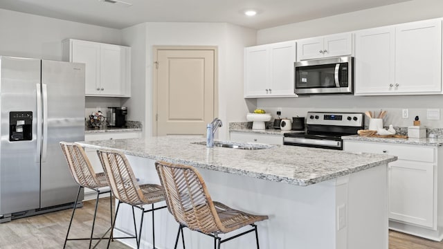 kitchen with sink, stainless steel appliances, and white cabinets