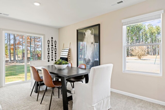 dining space with light colored carpet