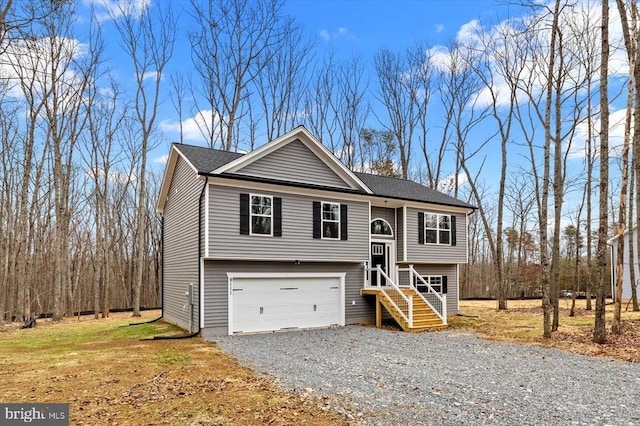 bi-level home with a garage and driveway