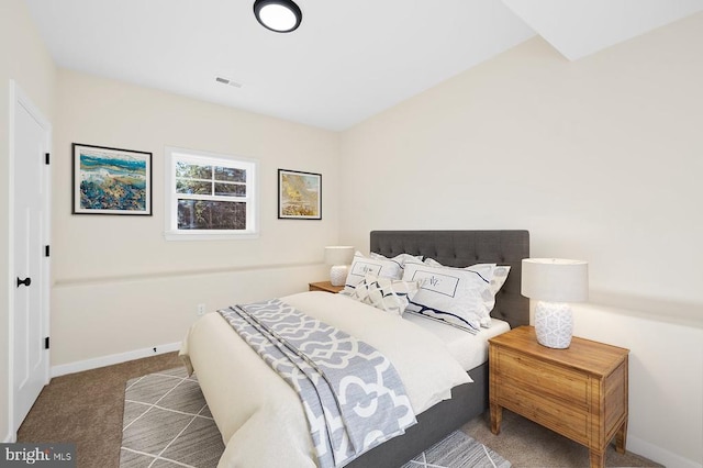 carpeted bedroom with visible vents and baseboards