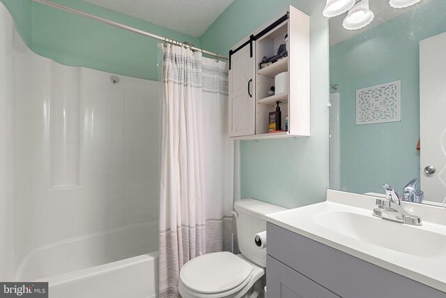 bathroom with shower / bathtub combination with curtain, a textured ceiling, toilet, and vanity