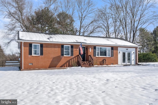 ranch-style house featuring french doors, brick siding, and crawl space