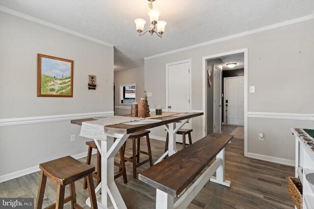 dining room featuring baseboards, a chandelier, dark wood finished floors, and crown molding