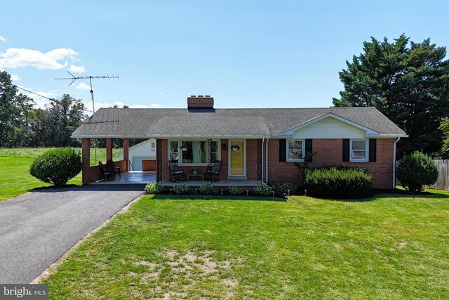 single story home with a garage, covered porch, and a front lawn