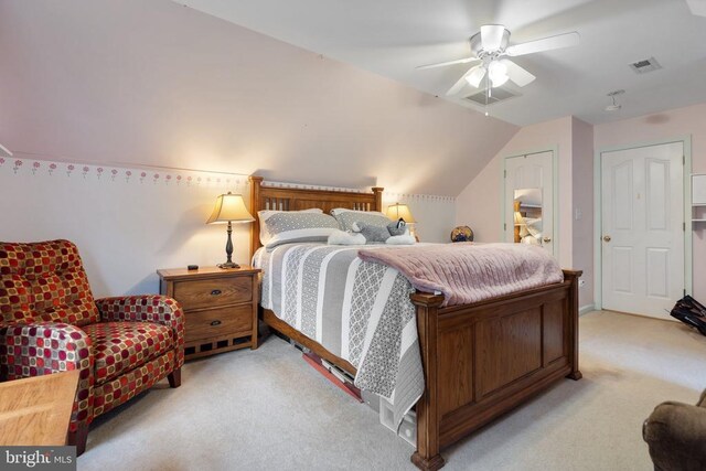 carpeted bedroom with ceiling fan and vaulted ceiling