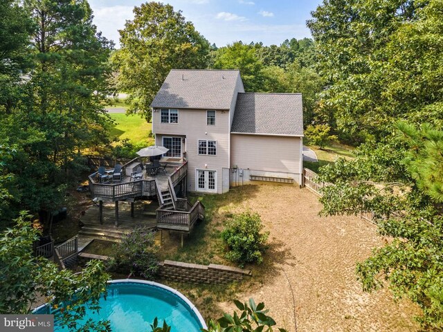 rear view of property with a swimming pool side deck