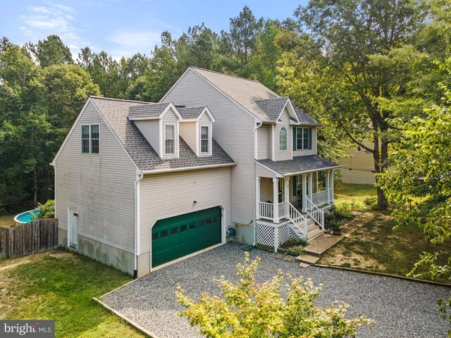 view of front facade with a porch, a garage, and a front yard