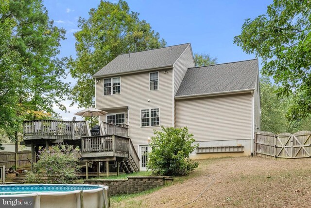 back of house featuring a pool side deck