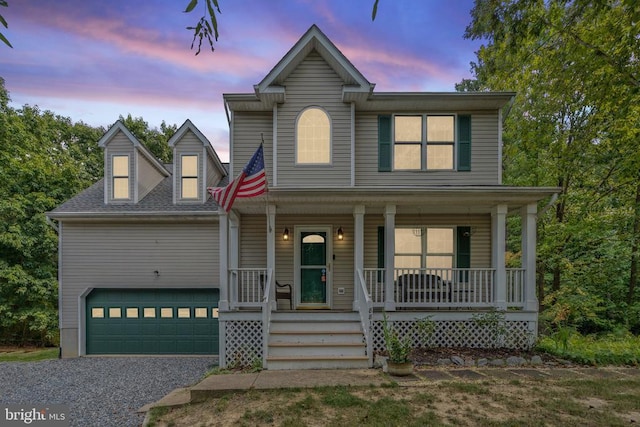 view of front facade with a garage and a porch