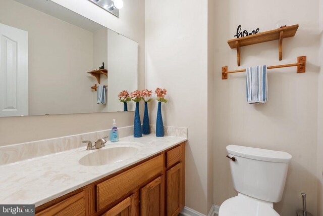 bathroom featuring vanity and toilet