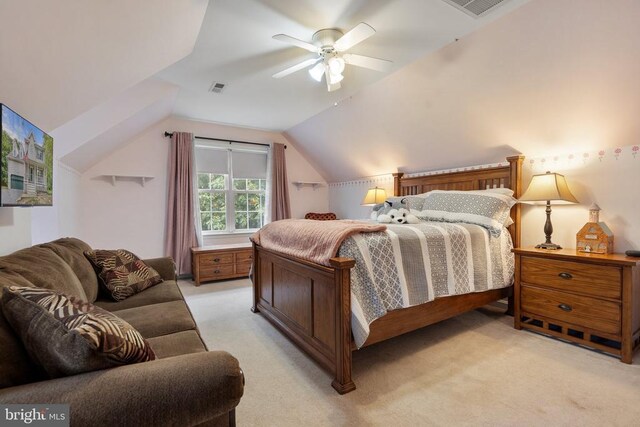 bedroom with vaulted ceiling, light colored carpet, and ceiling fan