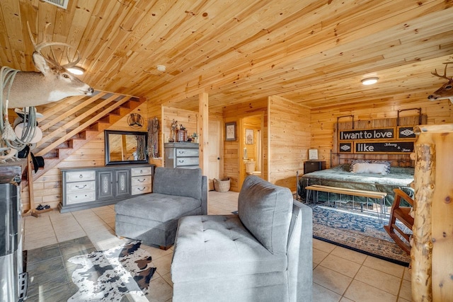 bedroom featuring wood ceiling, wooden walls, and light tile patterned floors