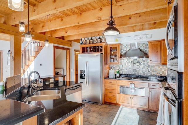 kitchen featuring pendant lighting, sink, backsplash, stainless steel appliances, and wall chimney exhaust hood