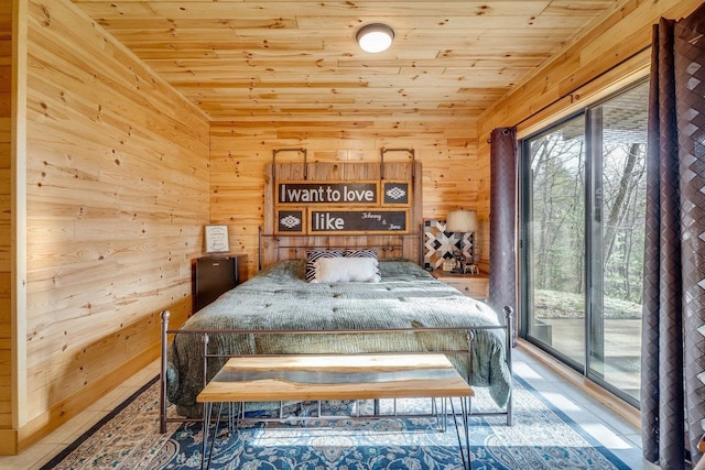 bedroom with access to exterior, wooden ceiling, and wooden walls