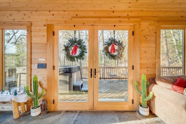 entryway featuring wood walls and french doors