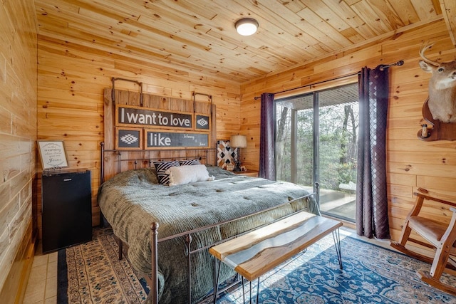 bedroom featuring wood walls, access to exterior, tile patterned flooring, and wooden ceiling